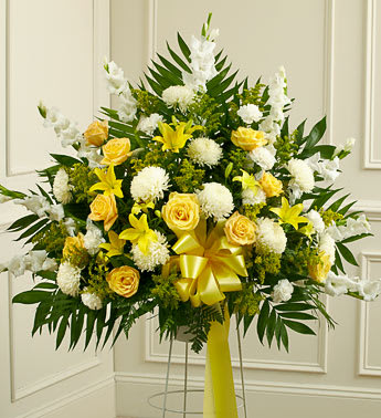 Yellow and white floral standing arrangement with a ribbon bow