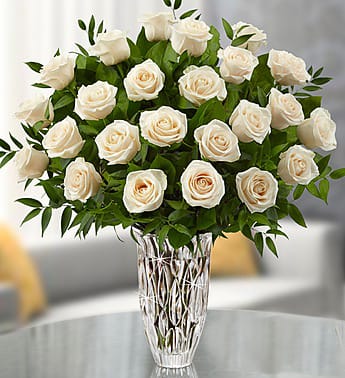 White roses arranged in a clear glass vase