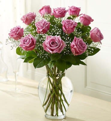 Pink roses arranged in a clear glass vase
