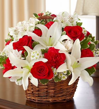 Basket of red roses and white lilies with small white filler flowers