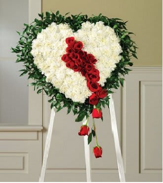 Heart-shaped floral standing spray with white flowers and red roses