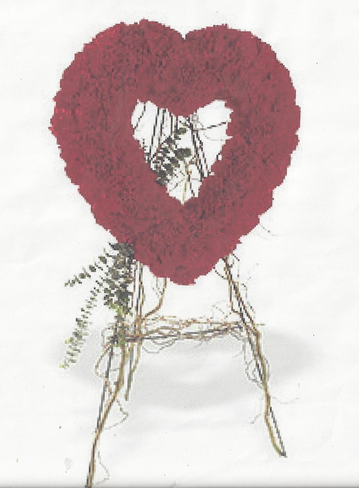 Heart-shaped red floral wreath with a white center on a stand