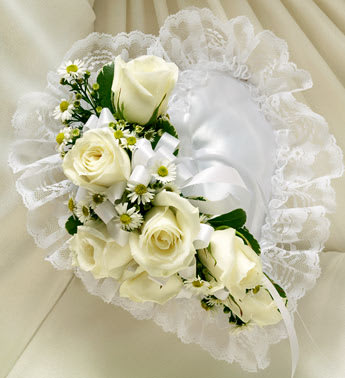 White rose bouquet with small daisy-like flowers and a satin ribbon