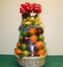 Basket of assorted fruit wrapped in clear cellophane with a red bow