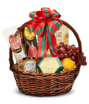 Gift basket with cheese, crackers, grapes, and fruit in a wicker basket