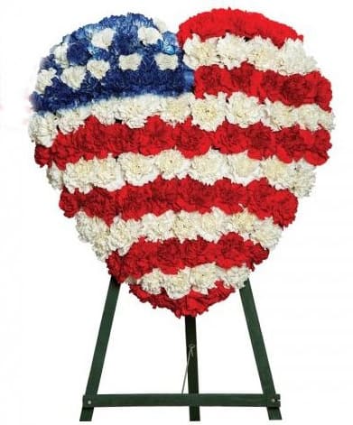Heart-shaped red, white, and blue floral standing tribute on an easel