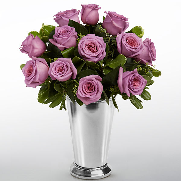 Lavender roses arranged in a silver vase