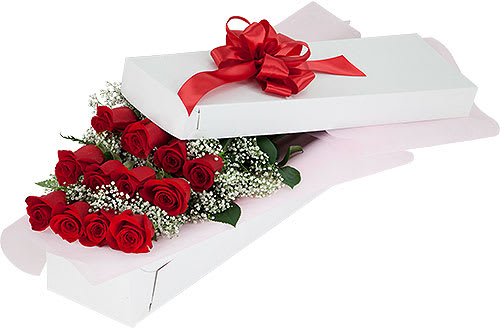 Red roses in a white gift box with a red ribbon