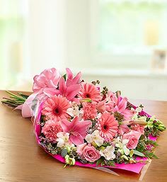Pink mixed flower bouquet wrapped in bright paper