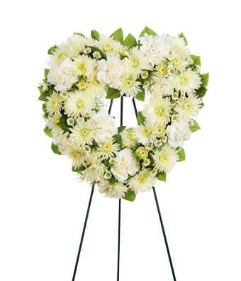 White floral standing wreath on an easel
