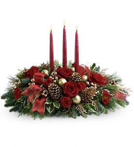 Holiday centerpiece with red roses, pinecones, and three red taper candles