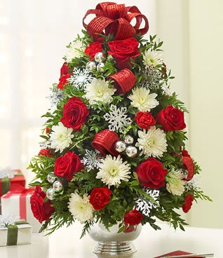 Christmas tree-shaped bouquet of red roses and white flowers in a vase