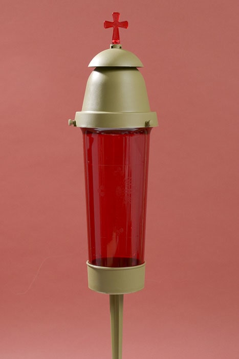 Red glass memorial candle lantern with a cross topper