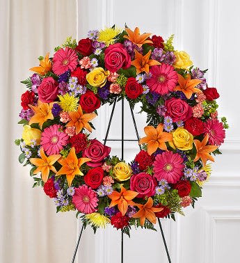 Colorful floral wreath on a black stand