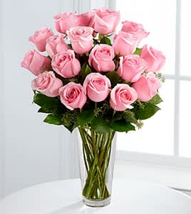Pink roses arranged in a clear glass vase