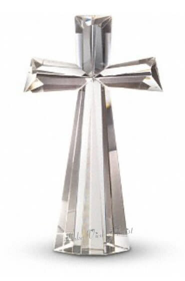 Silver cross-shaped decorative object with a long hanging ribbon