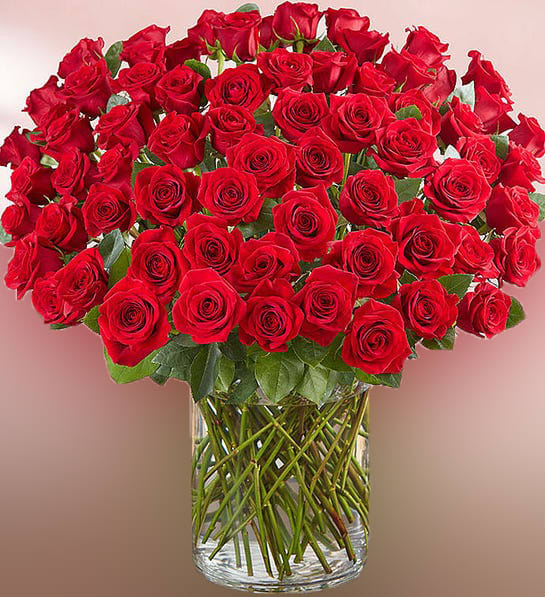 Large bouquet of red roses in a clear glass vase