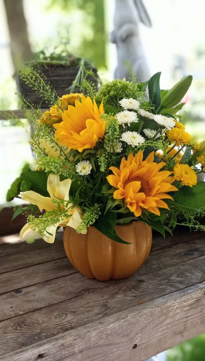 Sunflower and white daisy arrangement in a pumpkin-shaped container