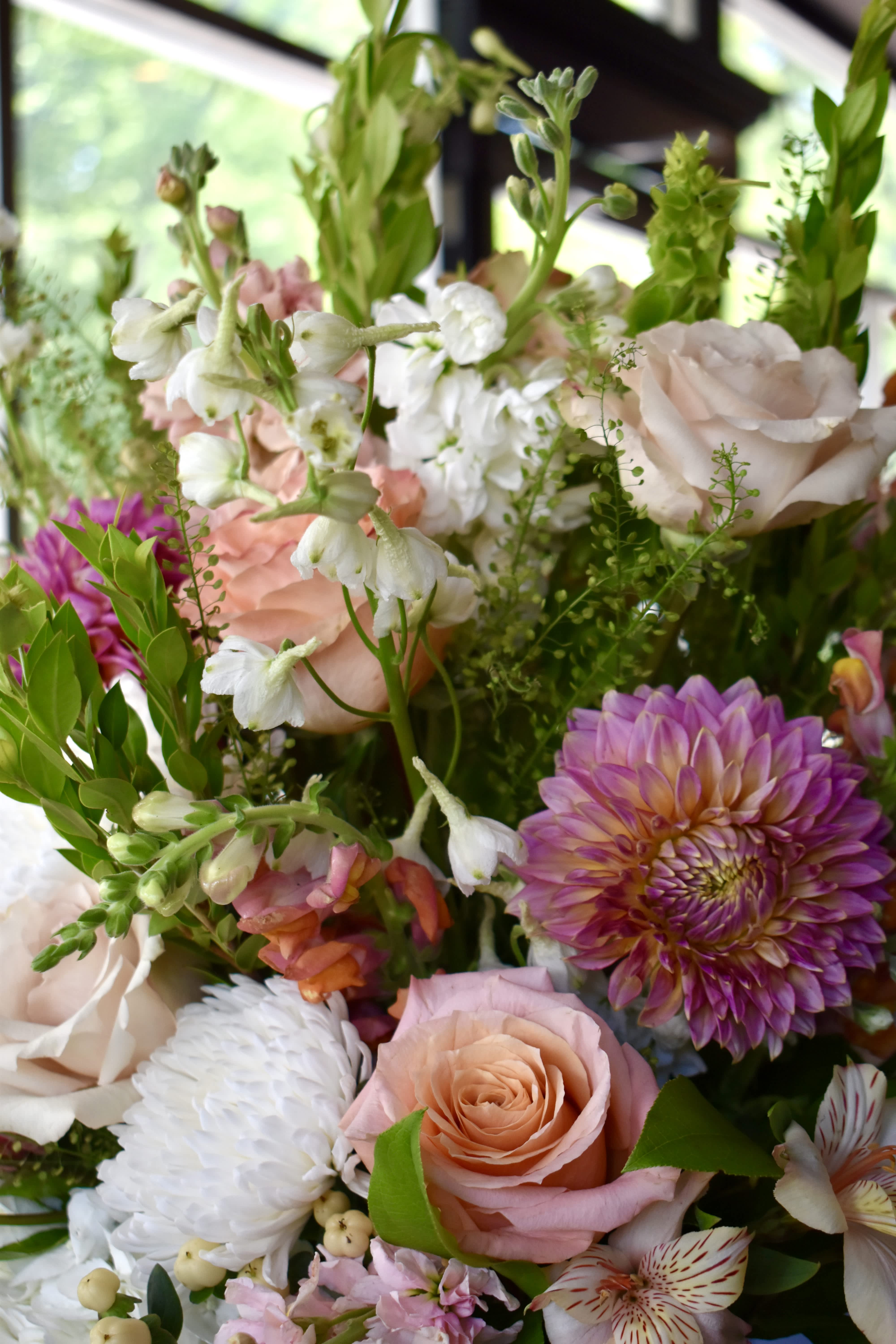 Mixed bouquet with pink roses, white blooms, and purple dahlias