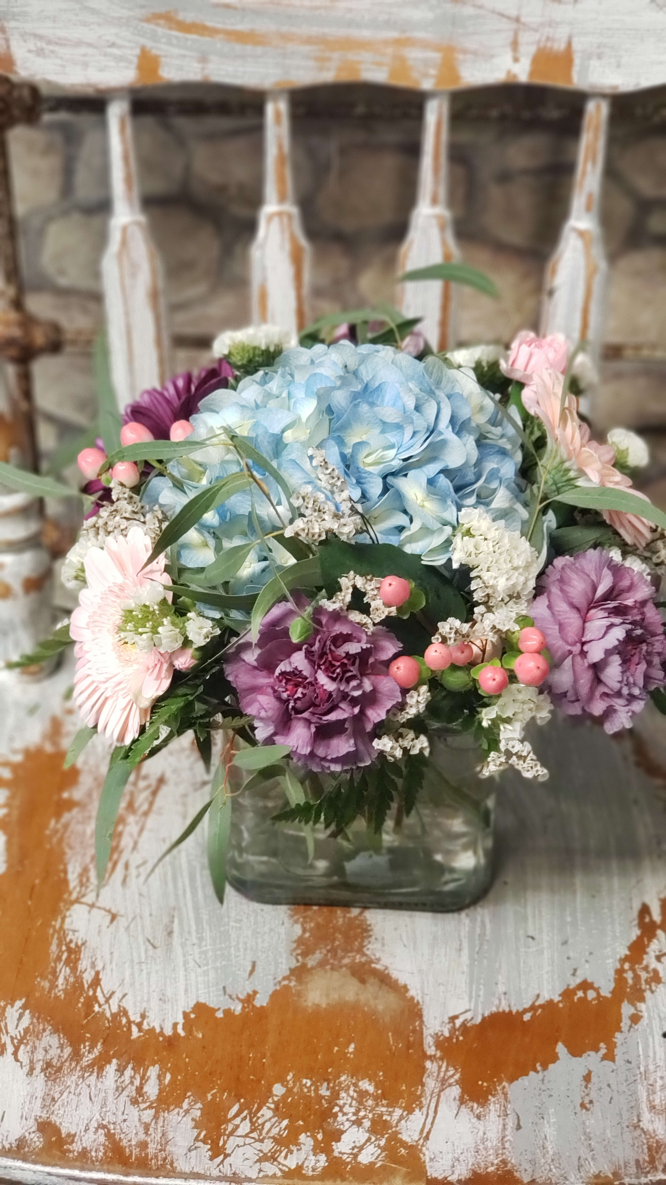 Laura's Choice  - Limited!! BLUE, WHT, GREEN . Hypericum berries &amp; plum Select Carnations are not available at all times. Some varieties can be limited from grower direct. SIMILAR DESIGN &amp; COLOR THEME whenever possible.  The pastel mixture of flowers and texture will please &amp; fit many occasions.  A pleasant gender mix for the birth of a new baby.  