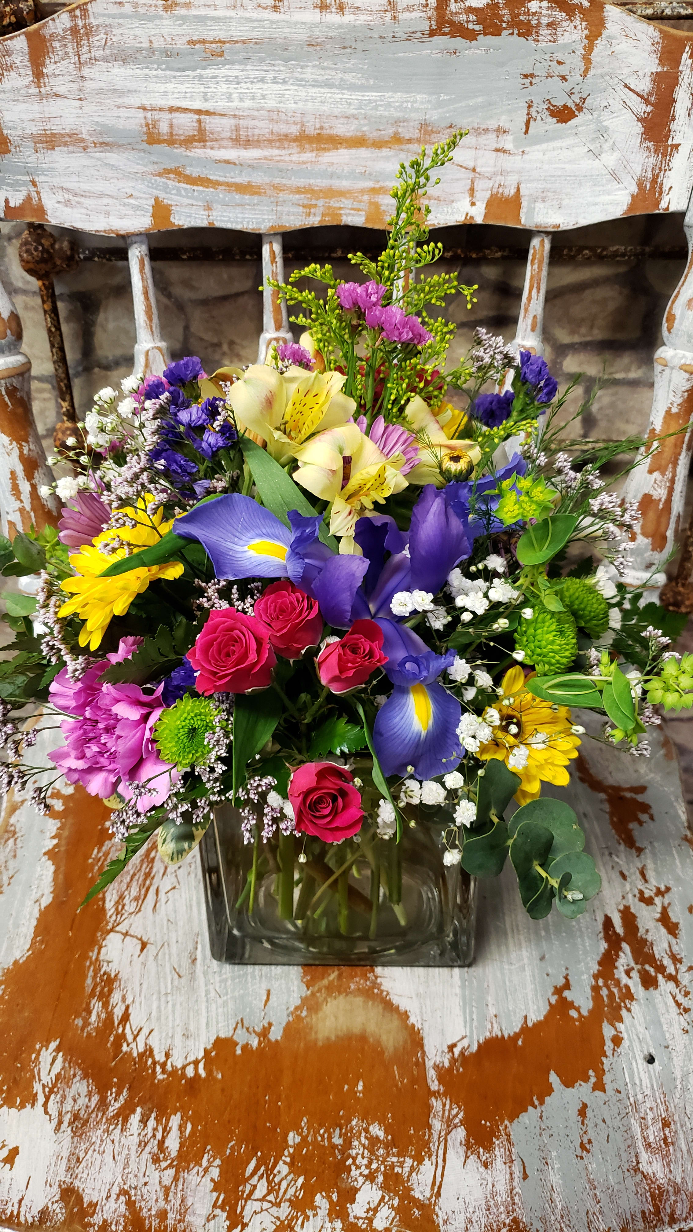 Bloomsbury Mix -  LIMITED AVAILABILITY! Brighten anyone's day with this cheerful &amp; colorful cube or cylinder design. Iris isn't available everyday! Flower variety can vary based upon market fresh selection at time of order. Seasonal product availability can effect variety availability. Style &amp; size starting at 4x4 cube or cylinder for standard designs. deluxe designs in larger glass vase. Premium designs are in an upgraded glass container..cube or cylinder style.