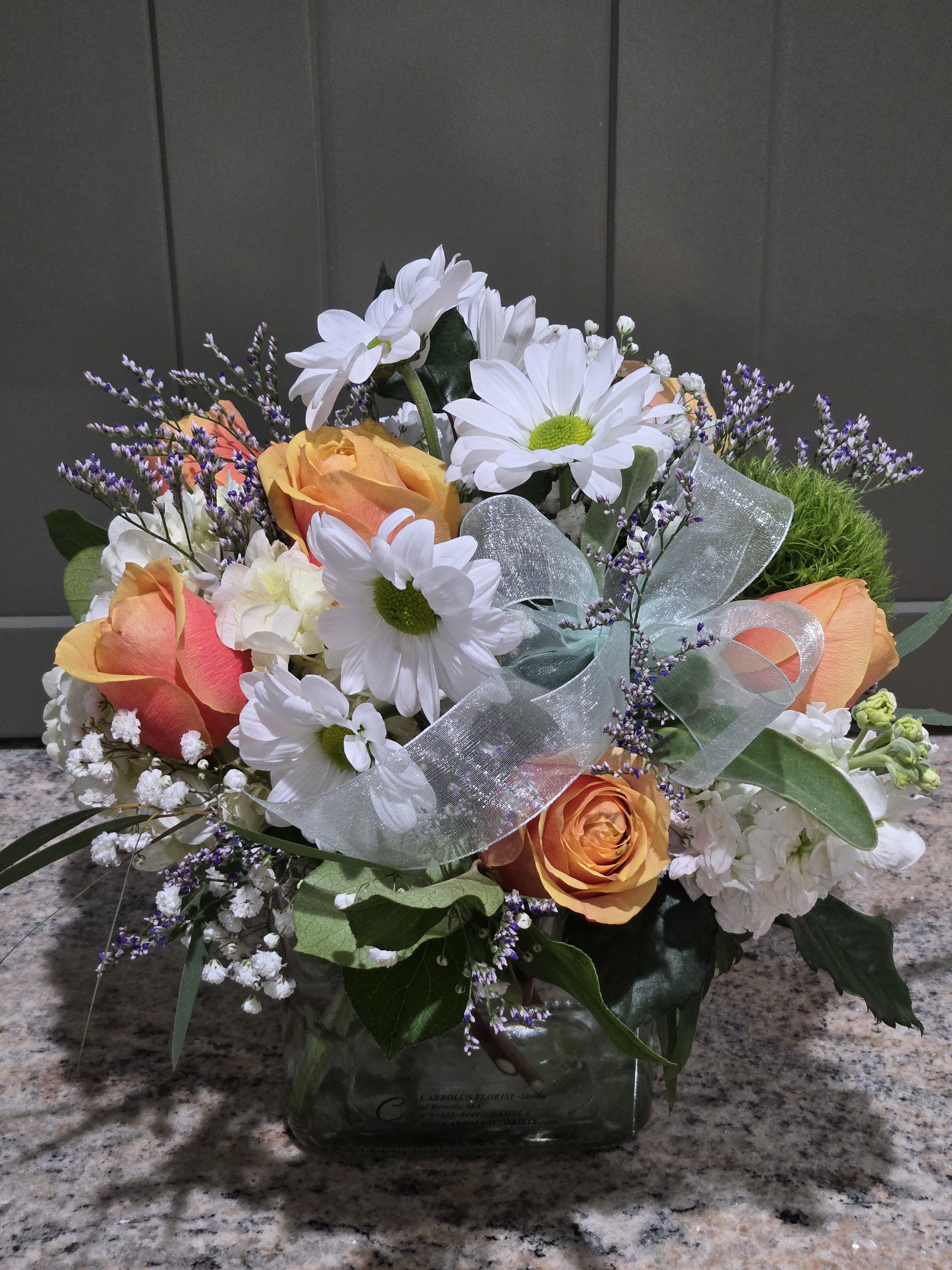 For My Sweet Peaches  - Compact Pave' designed in a sq cube or Rounded Grechian glass vase.  (Displays a few inches higher than cube) Let us know!? Peach or Catalope color themed Rose's, with Caspia (when available)   Gyp-AKA Babies Breath, greens, Green Trix and White Daisy Poms. While the supplies last!  Could design in a round Grechian glass vase....Giving a 3-5" higher design. Only for STANDARD or DELUXE choices. Grechian Vase, has one size and isn't available for Premium choice. 