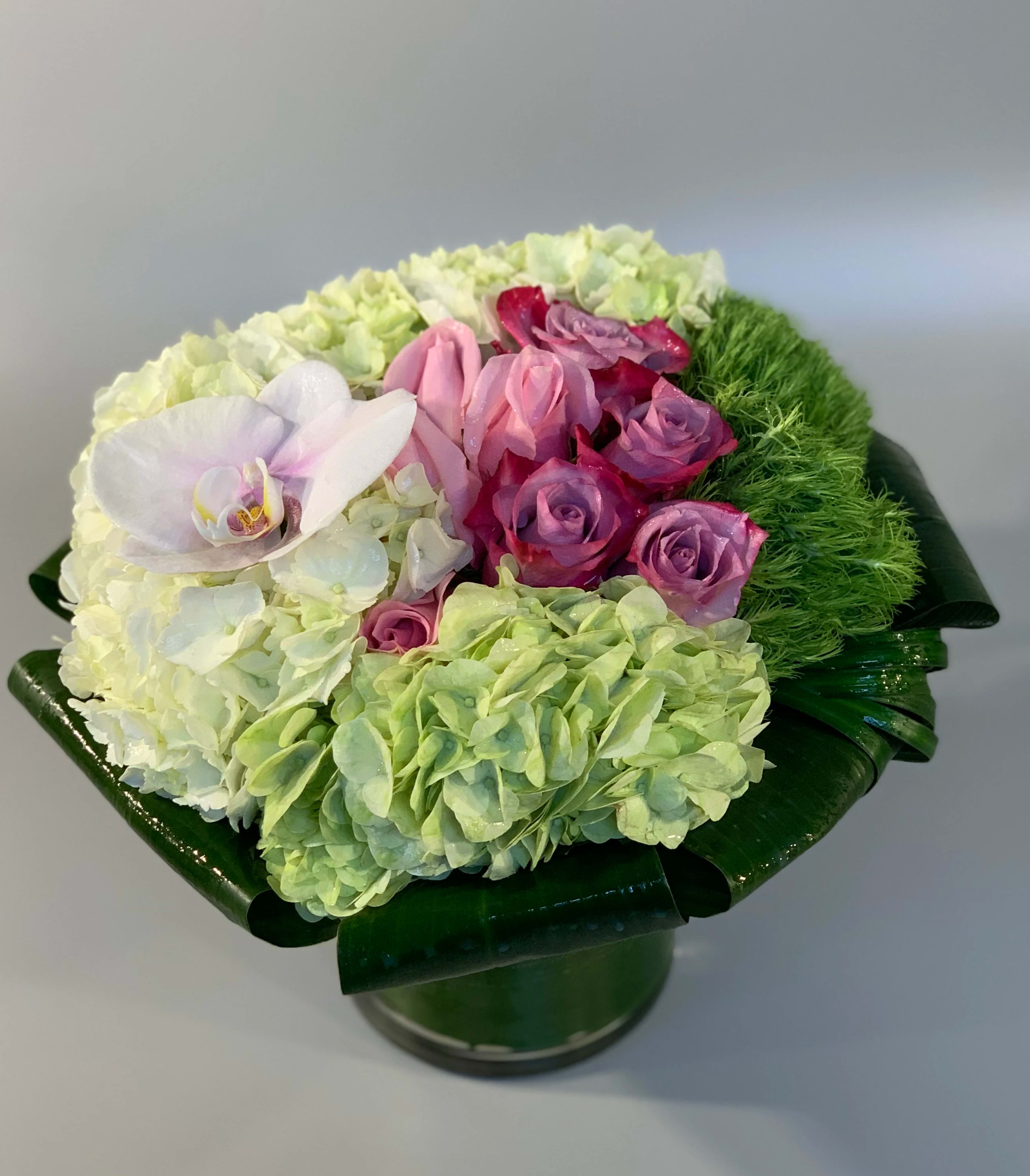 BLOSSOM - Designed with spring inspired colors and textures, designed in a glass vessel.   Colors may vary.