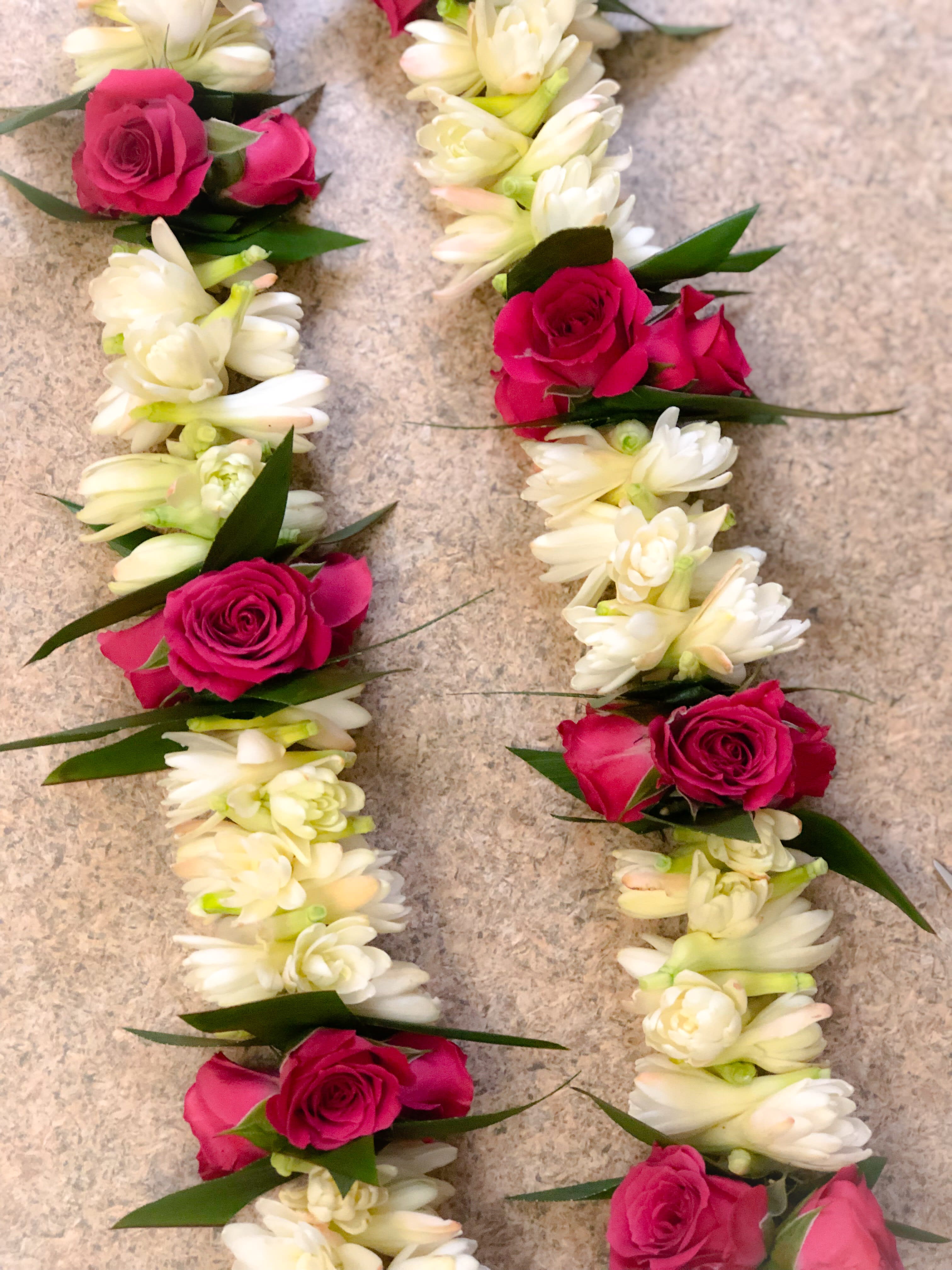 Double Tuberose lei with Ti Leaf and Spray Roses - This beautiful and fragrant lei is great way to show love for any special occasion. PLEASE ORDER AT LEAST 3 DAYS IN ADVANCE. Thank you!   PLEASE SPECIFY YOUR FIRST AND SECOND CHOICE OF COLOR FOR THE SPRAY ROSES.  COLORS: Pink, Hot pink, Lavender, Red, Yellow, Orange or White  This lei is made to approximately 38 inches long.