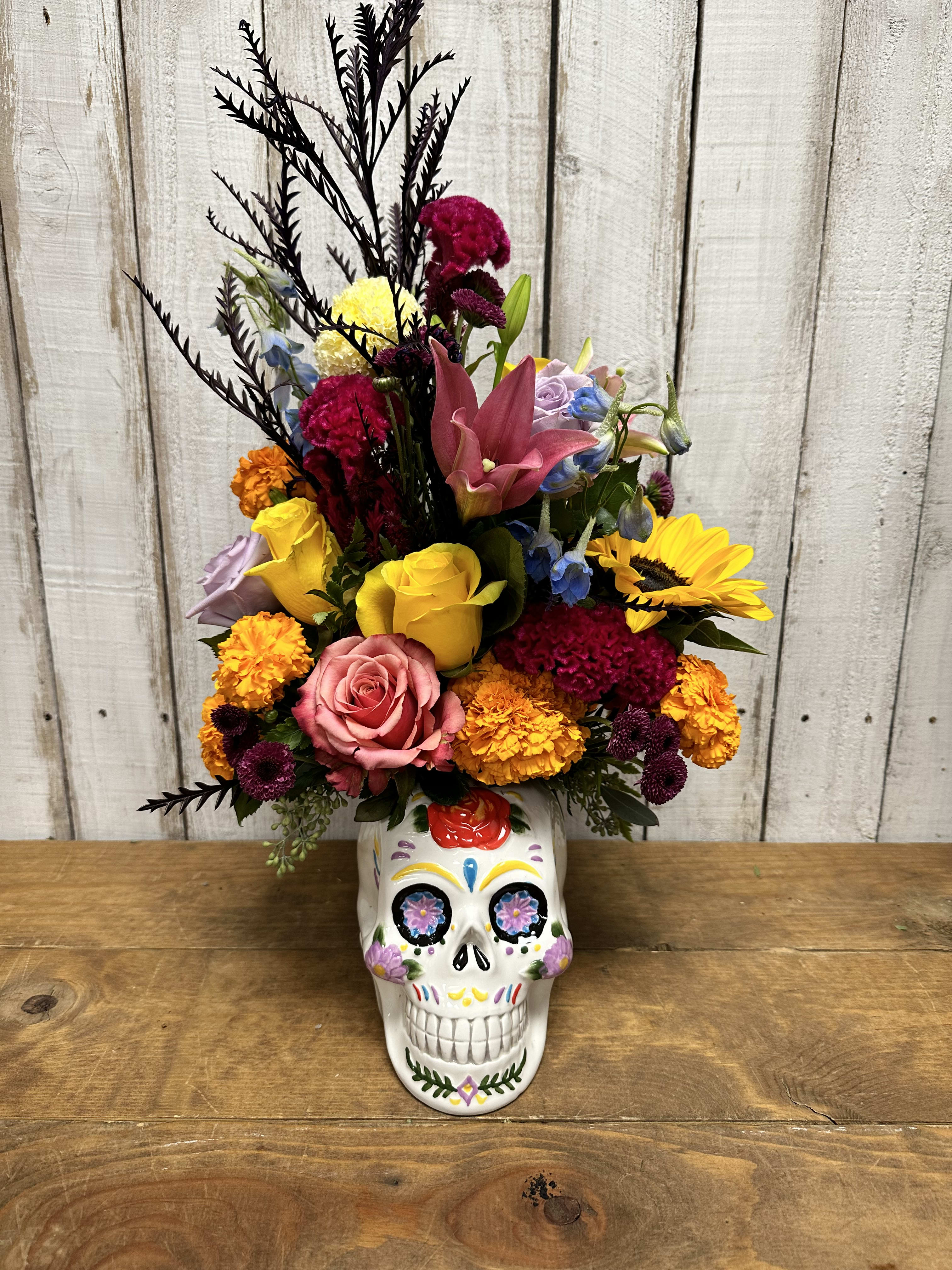 Dia de los muertos  - Dia de los muertos Beautiful flower arrangement consisting of roses, carnations, marigolds, chrysanthemums, delphinium, and other beautiful, fillers flowers designed in a keepsake ceramic container day of the dead November 1 and 2nd 