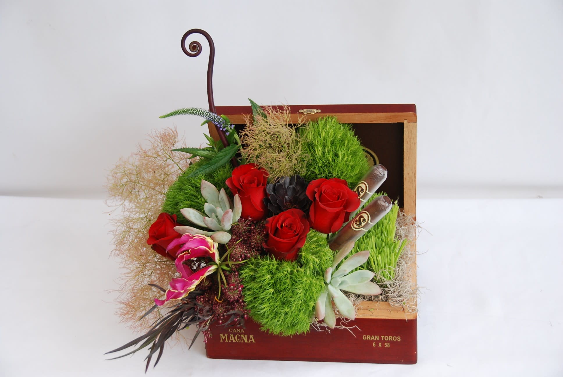 Flowers in Burbank - If you are looking for flowers in burbank ca, we created an arrangment in cigar box with red roses, gloriosa lily, green dianthus, monkey tail, succulents, and wheat grass. This makes a great gift for men!  