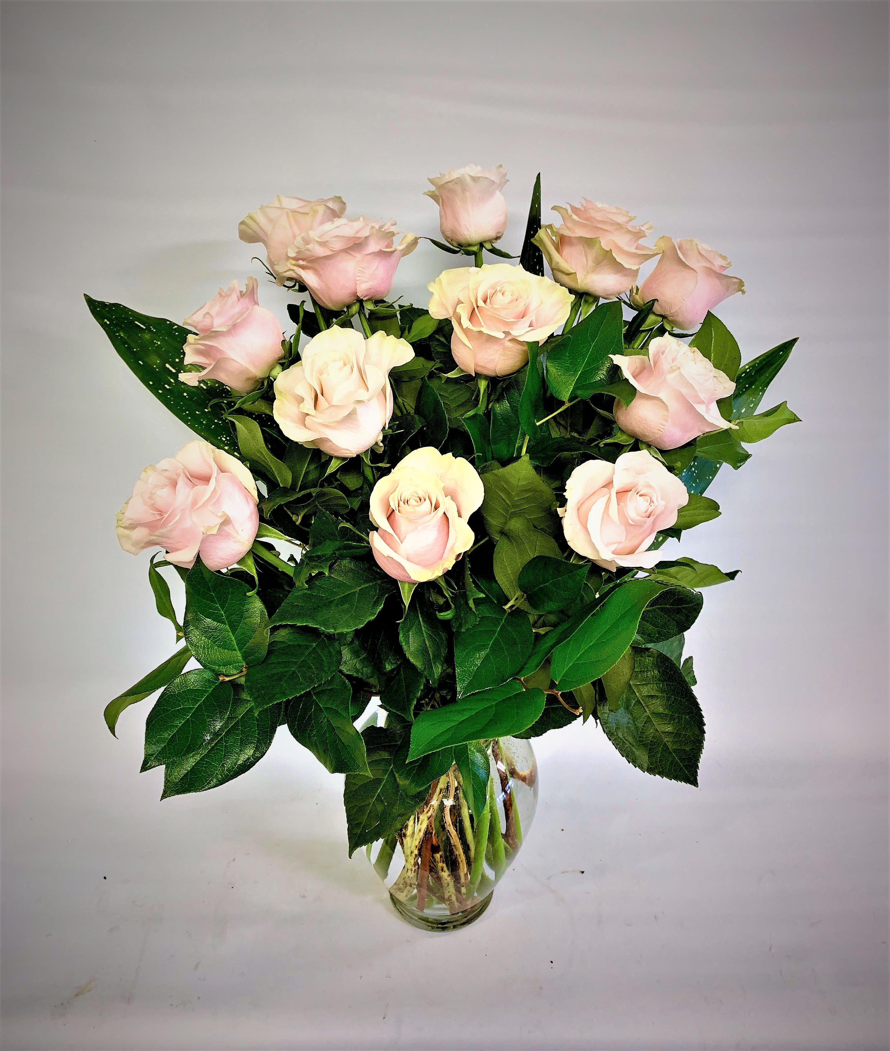 Sweet Pink Roses - A Beautiful Dozen Pink Roses Designed With Lush Greens In A Clear Glass Vase.  