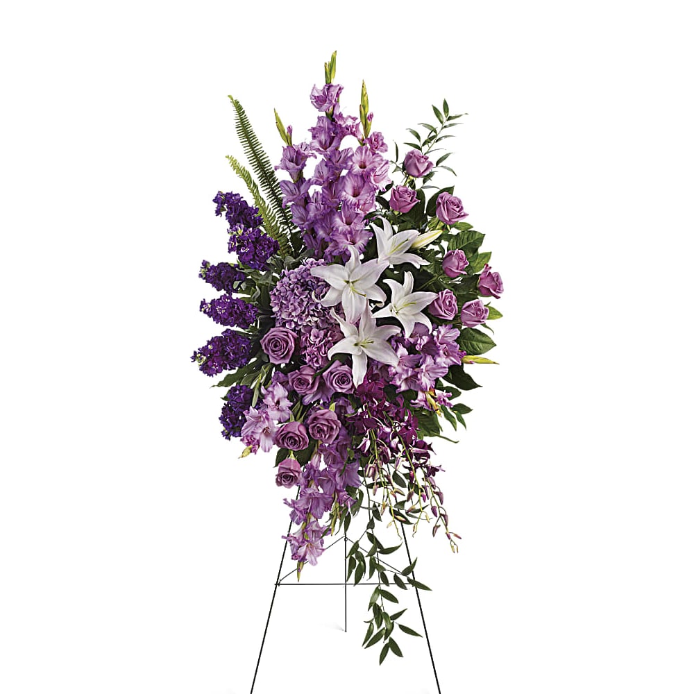 Tall purple and white floral standing spray on an easel