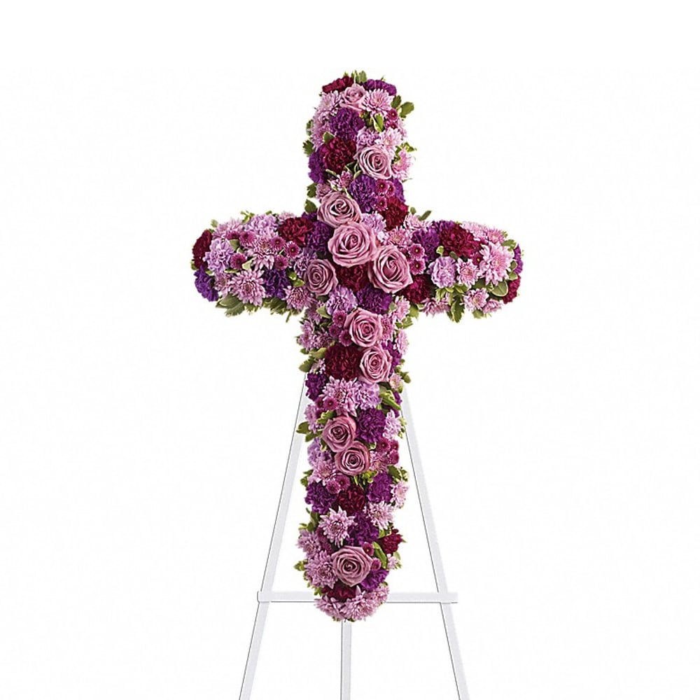 Purple and pink floral cross on a white stand