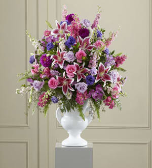 FTD Peaceful Tribute Arrangement - Extravagant, beautiful and comforting, this generously scaled arrangement eloquently expresses your sympathy with an abundance of love and a profound manifestation of loss. Handcrafted by a local FTD artisan florist, it combines a colorful profusion of lavender and hot pink roses, pink statice, purple lisianthus and dahlias, Stargazer lilies and lavender alstroemeria enhanced with a rich and exotic variety of lush greenery in a classically-inspired white ceramic urn. It’s an extraordinary choice that makes a big statement, sure to be noticed, greatly appreciated and long-remembered, for a wake or funeral service.