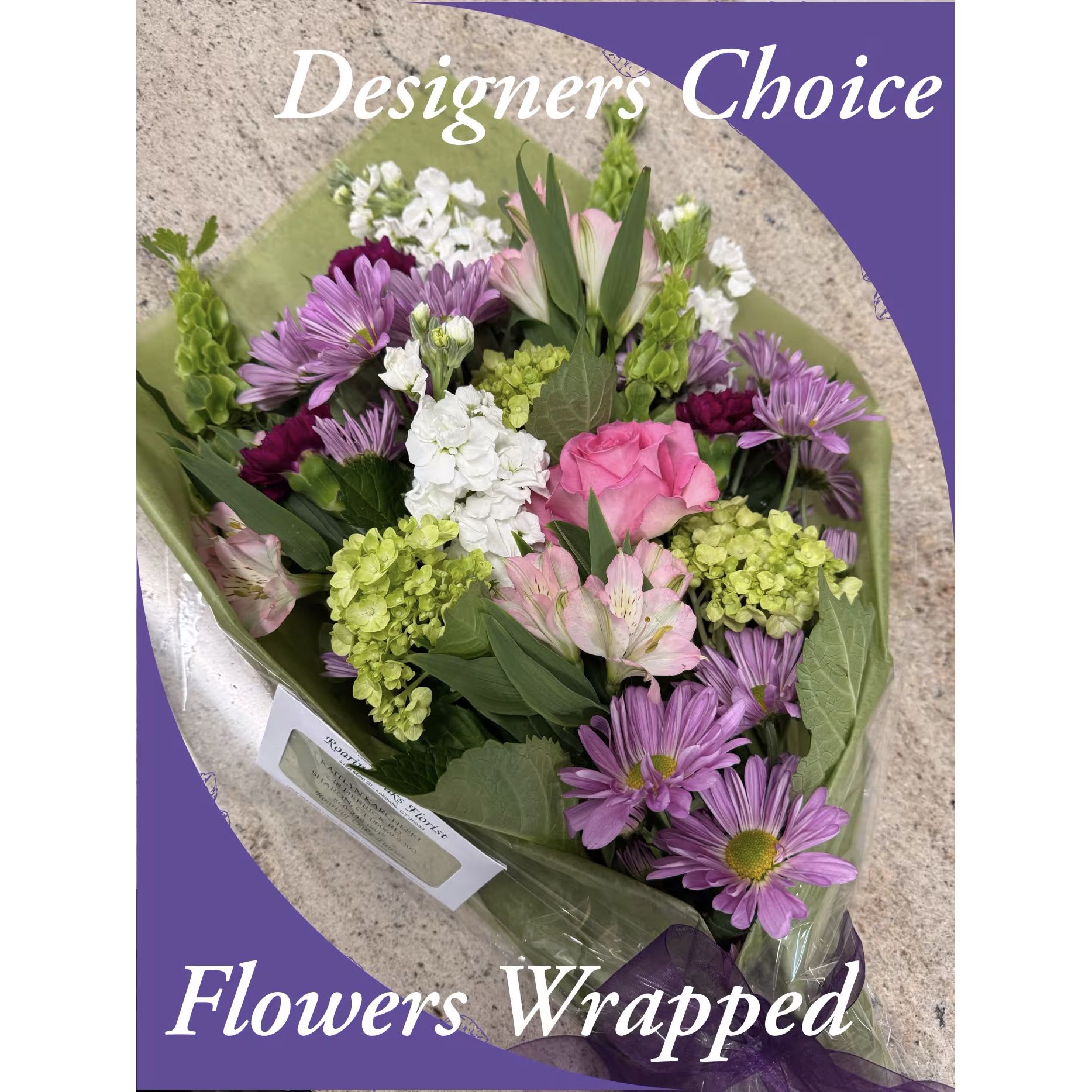 Wrapped bouquet of pink, purple, white, and green flowers