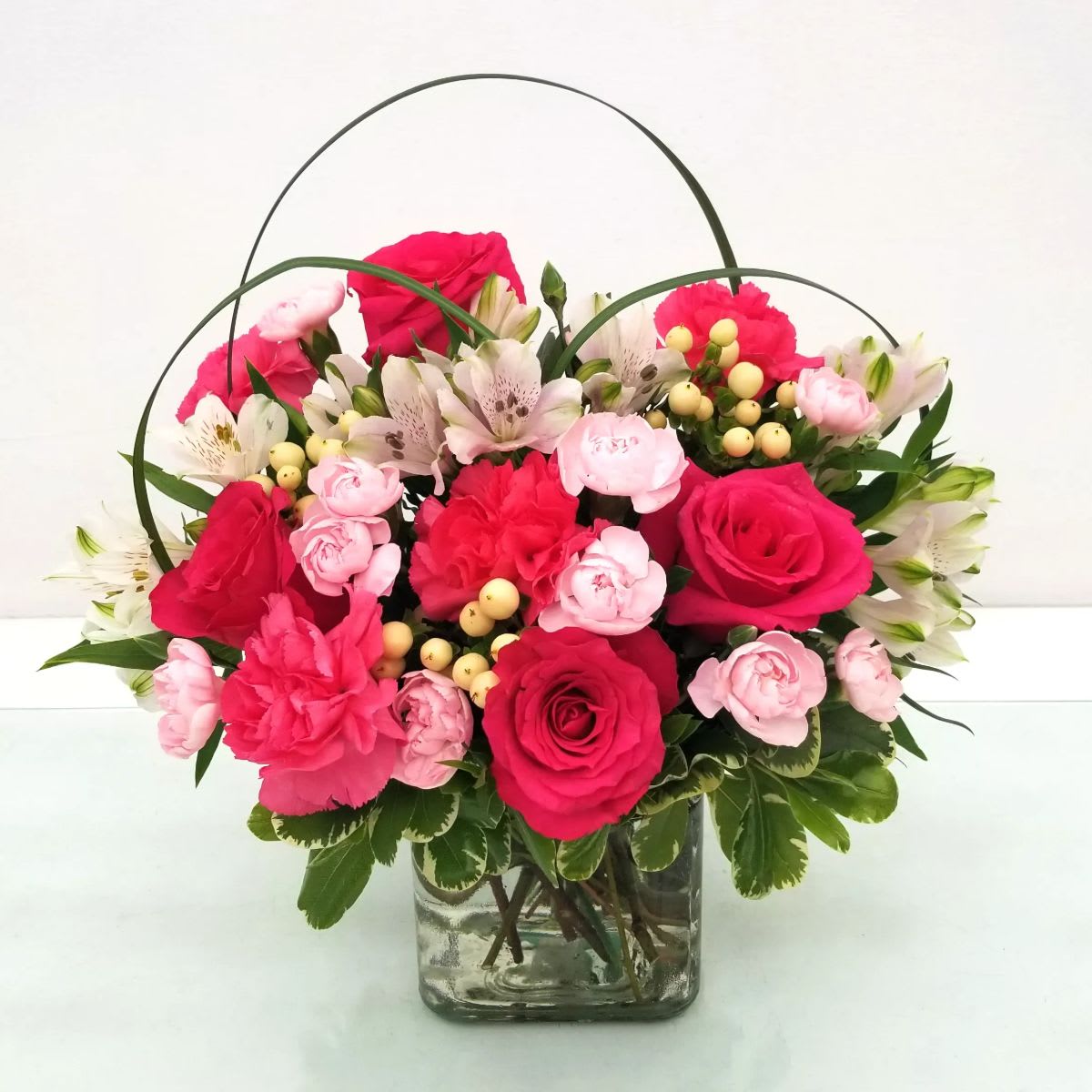 Pink Floyd - Pink Floyd Flower arrangement is a beautiful and unique bouquet that is sure to turn heads. The arrangement features hot pink roses, pink carnations, alstroemeria, and lush greens, all of which are displayed in a modern glass cube vase. The arrangement is perfect for any occasion, especially for the Barbie in your life. Also birthday, love and romance, Mother's Day or just because, the best reason of all.  Approximate size: 12" Tall by 12" Width  Pink Floyd from Long Beach best rated flower shop, offering same day flower delivery service, A Beautiful California Florist.  Note: Item not available to order/delivery, Feb 12th to Feb 15th. Please order from our Valentine's Day Selections. Thank you!