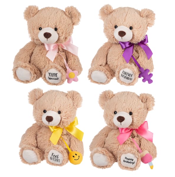 Four plush teddy bears with ribbons and small hanging charms.