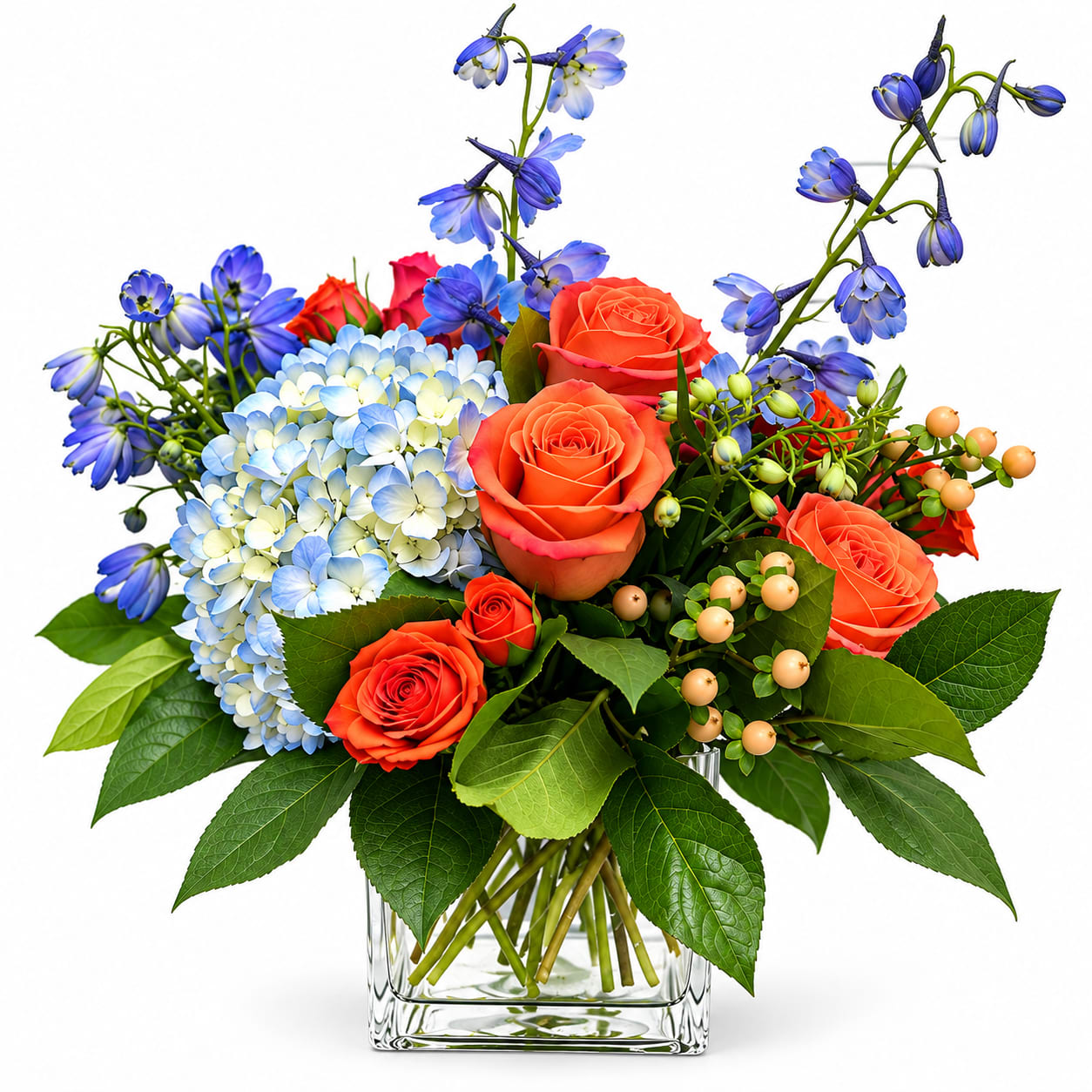 Bouquet of orange roses, blue hydrangea, and blue flowers in a glass vase
