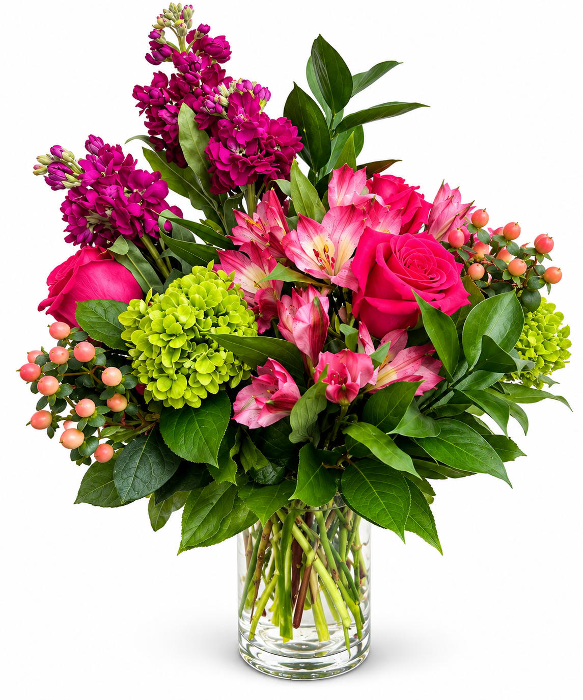 Pink and magenta flowers arranged in a clear glass vase