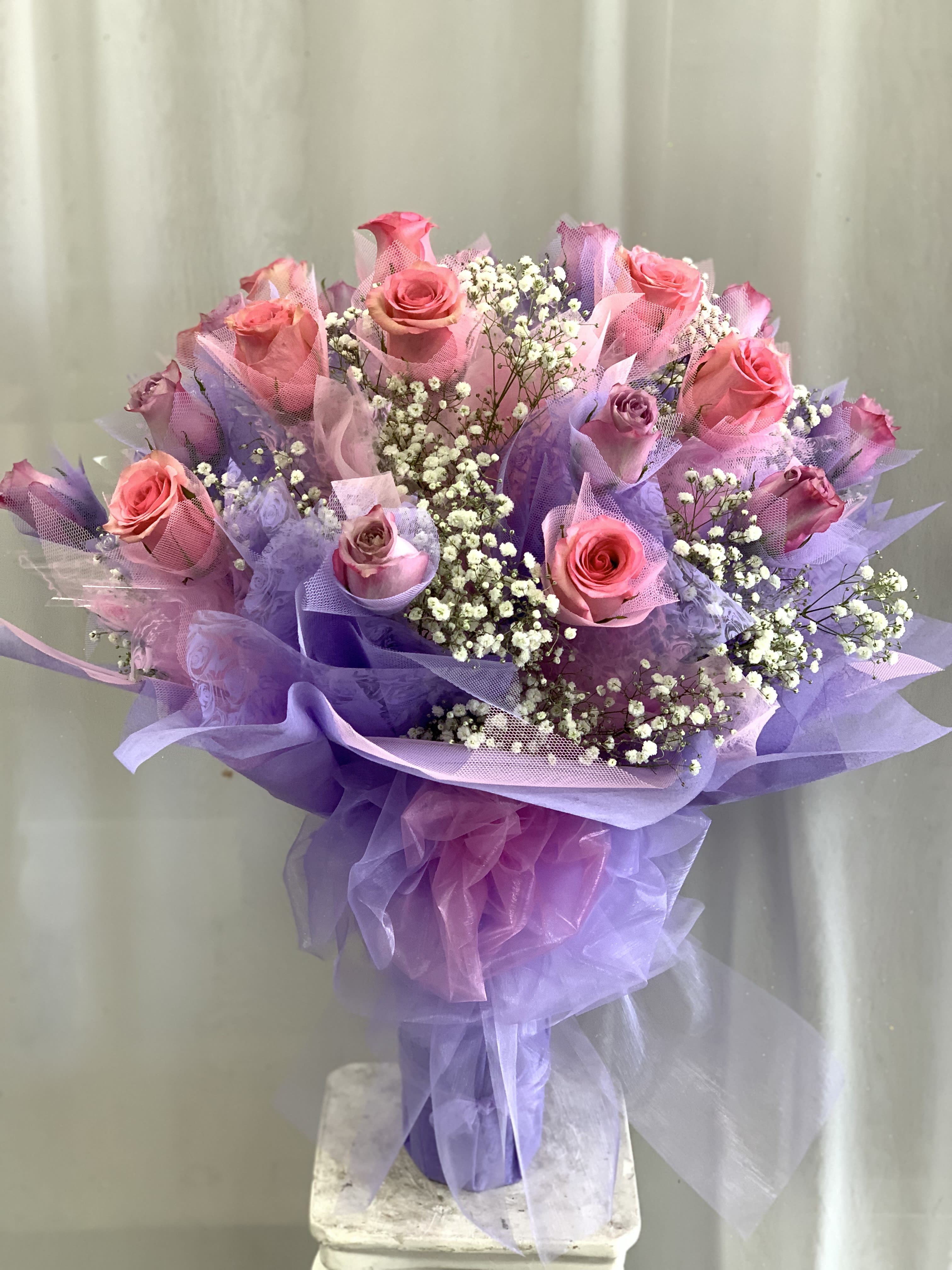 Hong Kong Style Roses Natural Pink &amp; Purple Roses  - Hong Kong Style Roses with natural pink &amp; purple roses *NON GLITTERED*   1/2 Dozen $165 1 Dozen $235 2 Dozen $445 Prices above include vase.    *** GRADUATION HONG KONG STYLE ROSES, PLEASE PHONE-IN  Hong Kong Style Roses WRAPPED ( without a vase) will come with water tubes/water pouch.   Recommended for graduations!  Additional $20    **Picture featured is 2 Dozen Roses