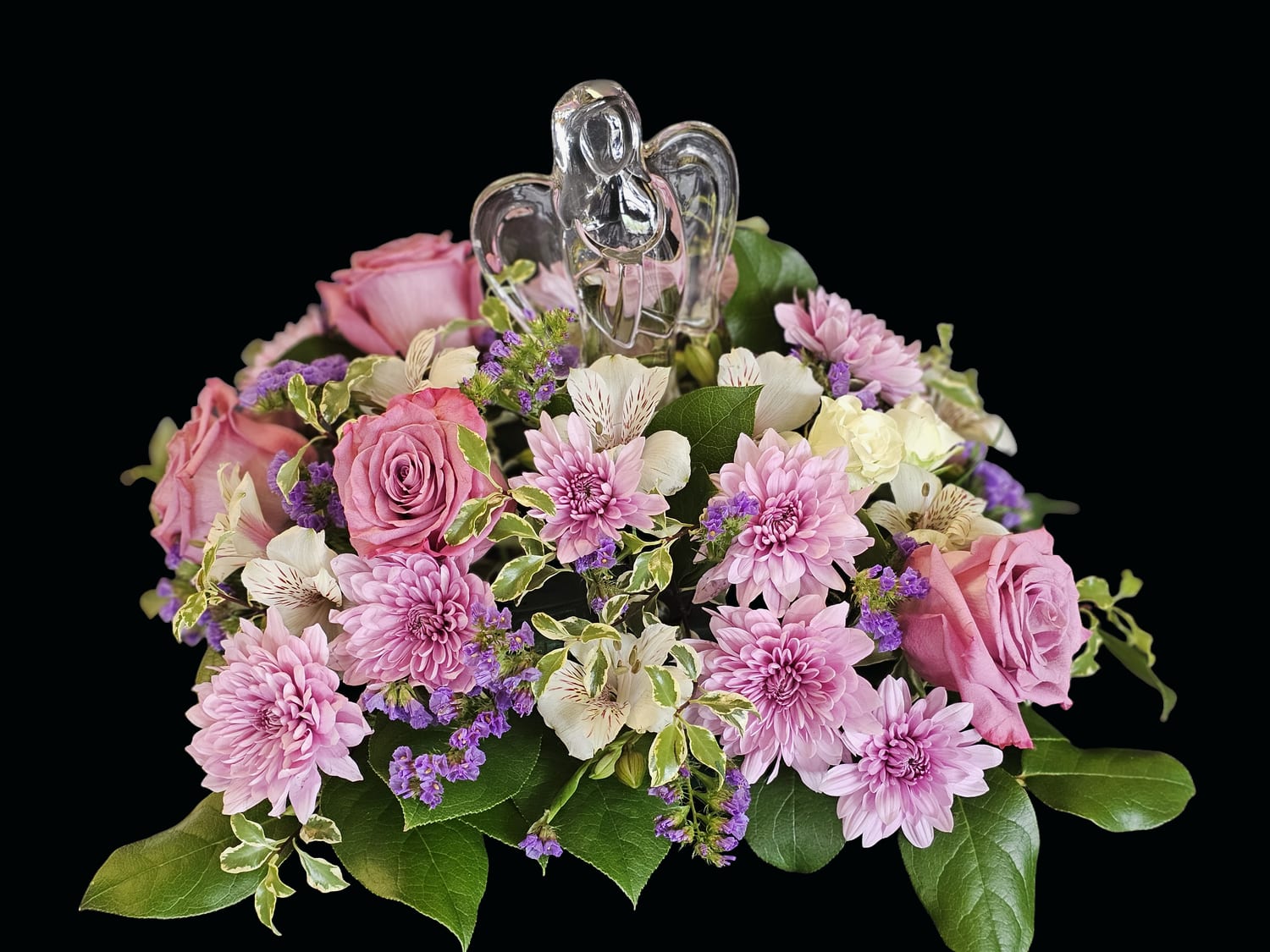 "She loved Angels"  - Designed to convey comfort and presence, this arrangement is ideal for expressing sympathy, honoring a memorial, or offering solace to someone grieving-the kind of gift that helps a person feel seen and remembered. The low profile works well on tabletops, memorial displays, or beside a casket.