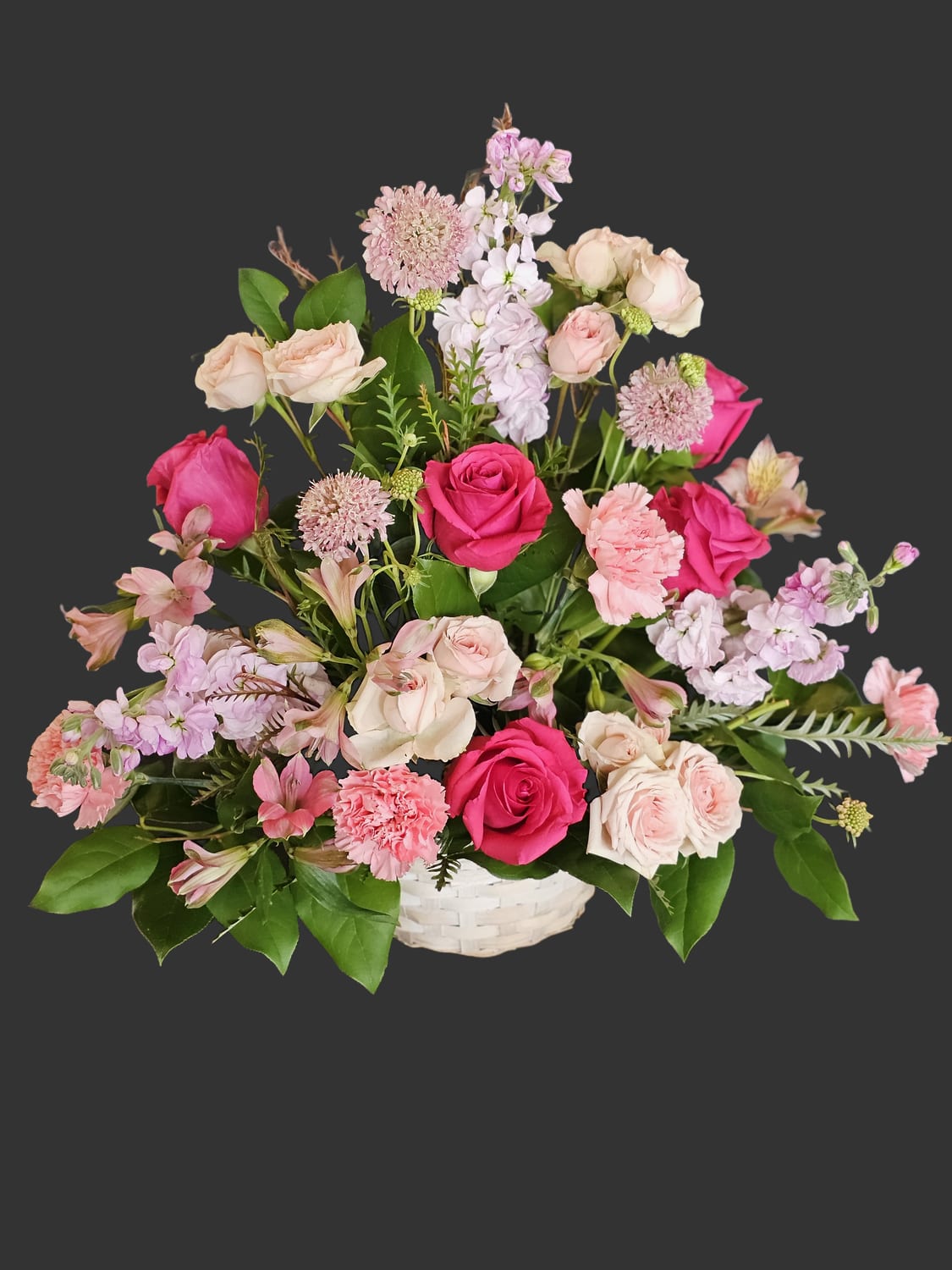Serene Blessings - A gentle blend of lavender, soft pinks, and creamy whites creates a comforting presence that soothes and honors-perfect as a sympathy or funeral flower arrangement. This flower arrangement is intended to offer serene condolences and quiet beauty for the person you're remembering, providing a thoughtful, tender expression when words fall short.  Made to comfort, this arrangement suits memorial services, wakes, or to send to a grieving household as a meaningful way to say you are thinking of them. The low basket keeps blooms arranged neatly for display.
