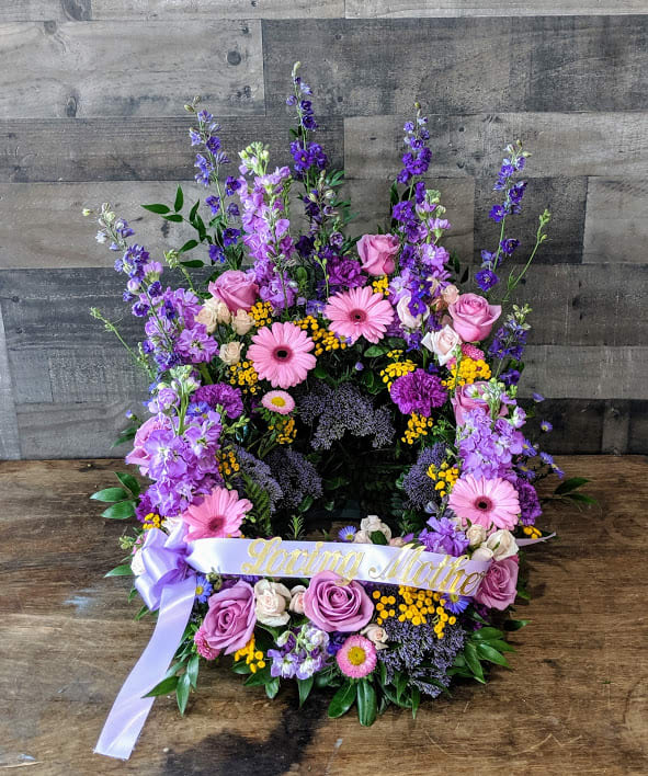 Tall purple and pink floral wreath with Loving Mother ribbon