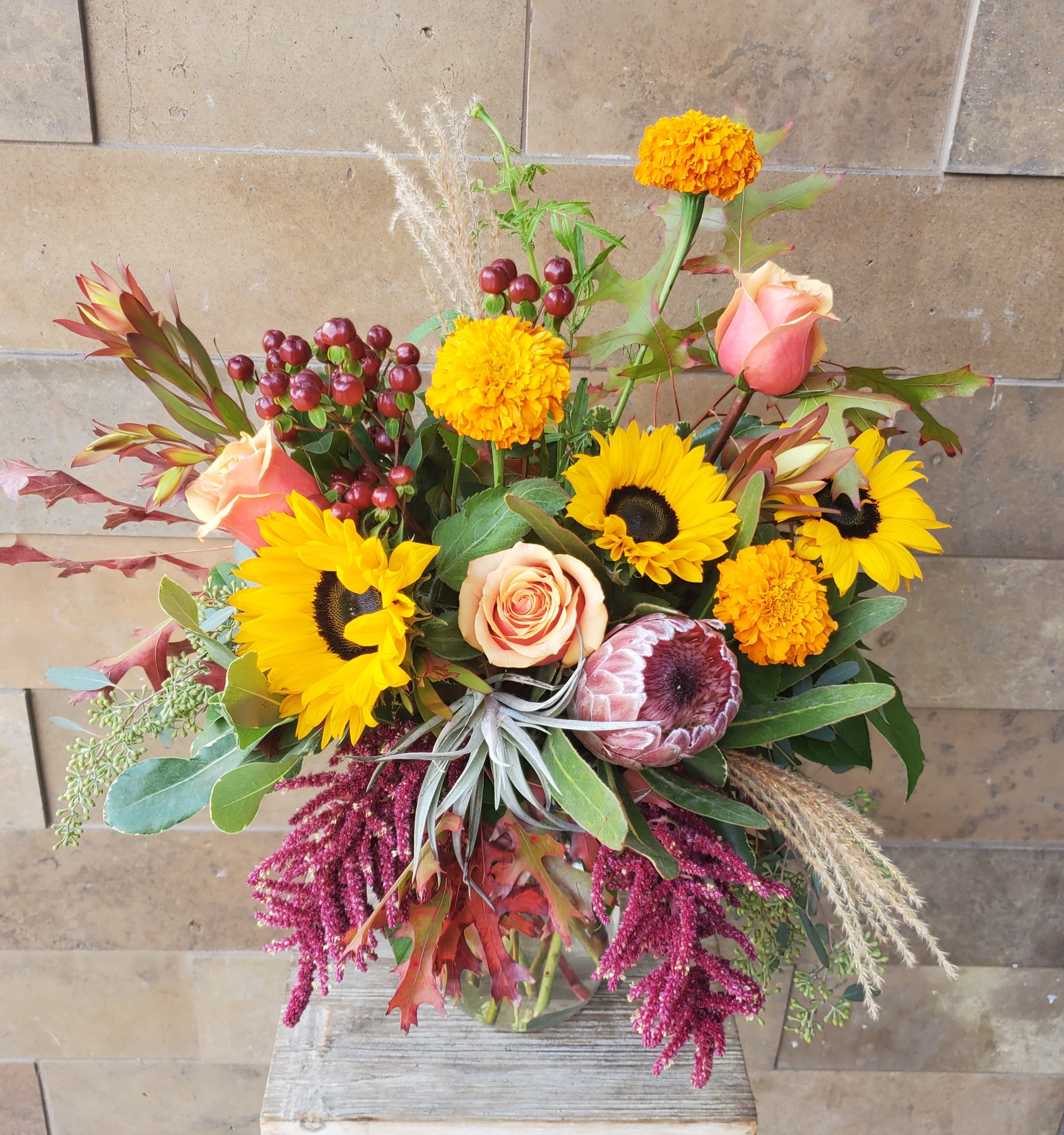 Sunflowers and Marigolds  - A Beautiful fall design, with an airplant keepsake.  Upright shape.
