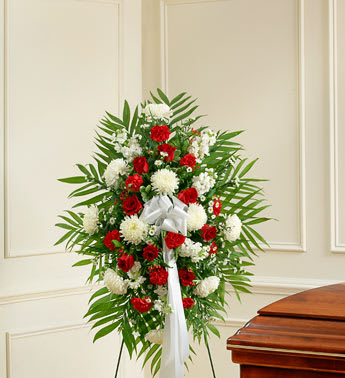 Standing floral spray with red and white flowers on an easel