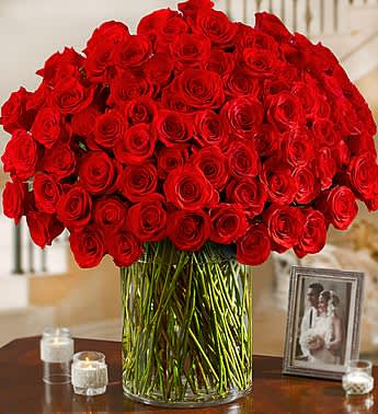Large bouquet of red roses in a clear glass vase