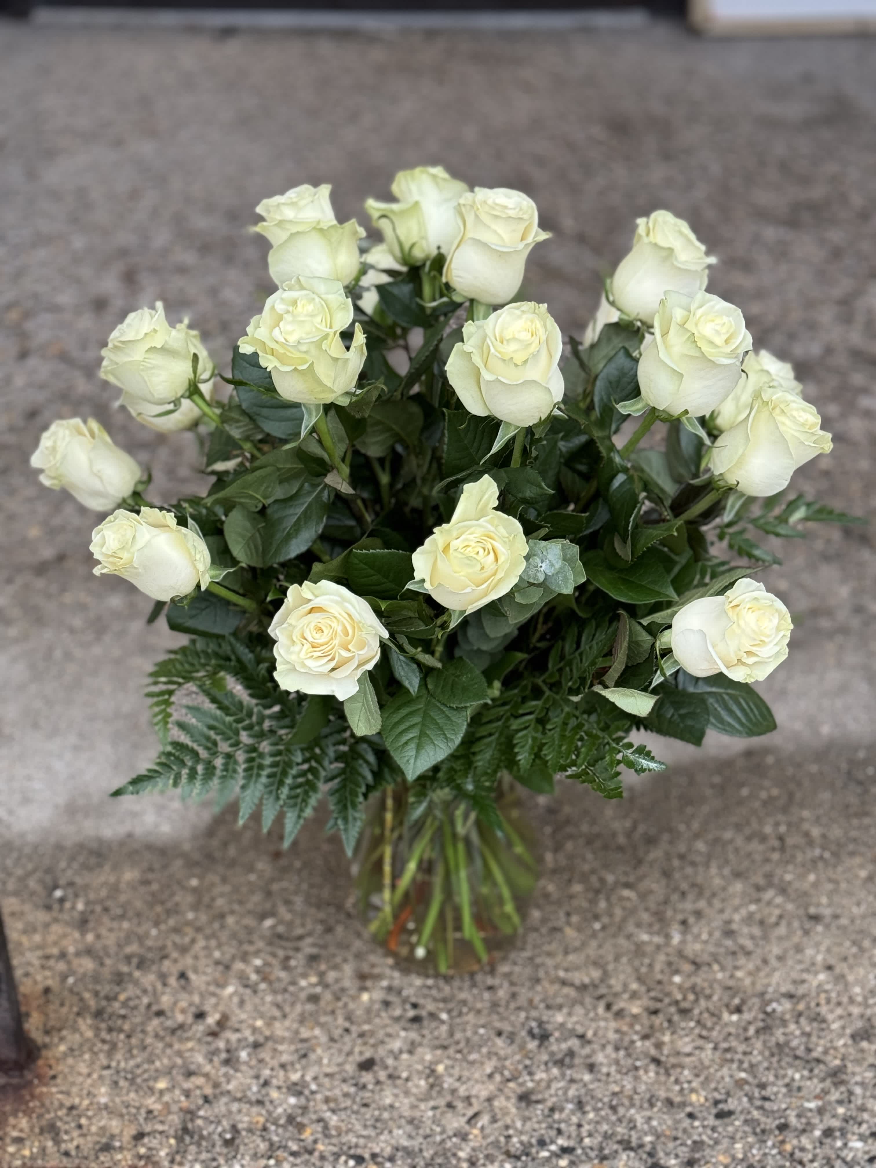 Bouquet of cream white roses in a glass vase