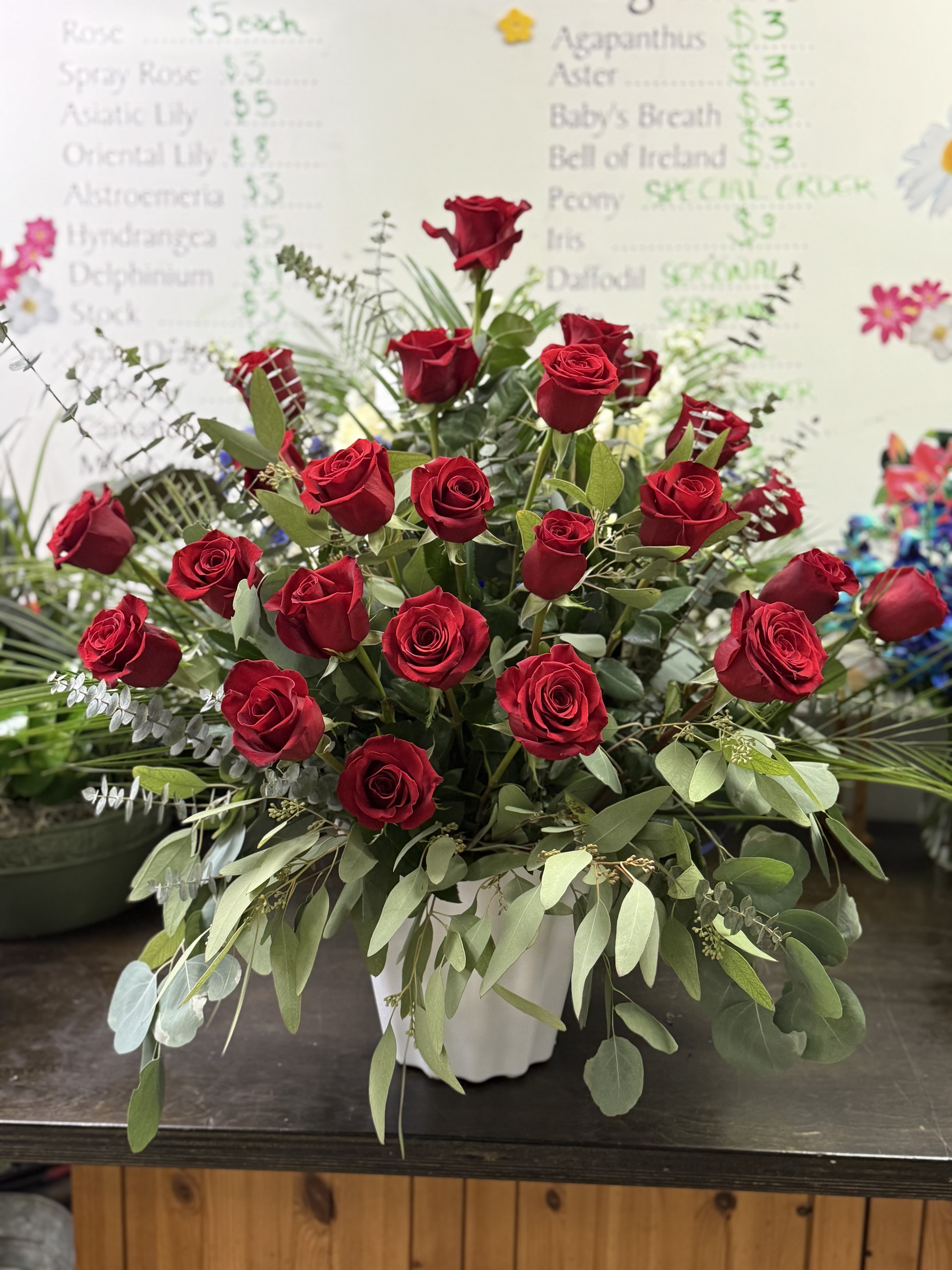 Red rose sympathy arrangement  - All red roses and foliage arranged to express your love and devotion to a loved one. 