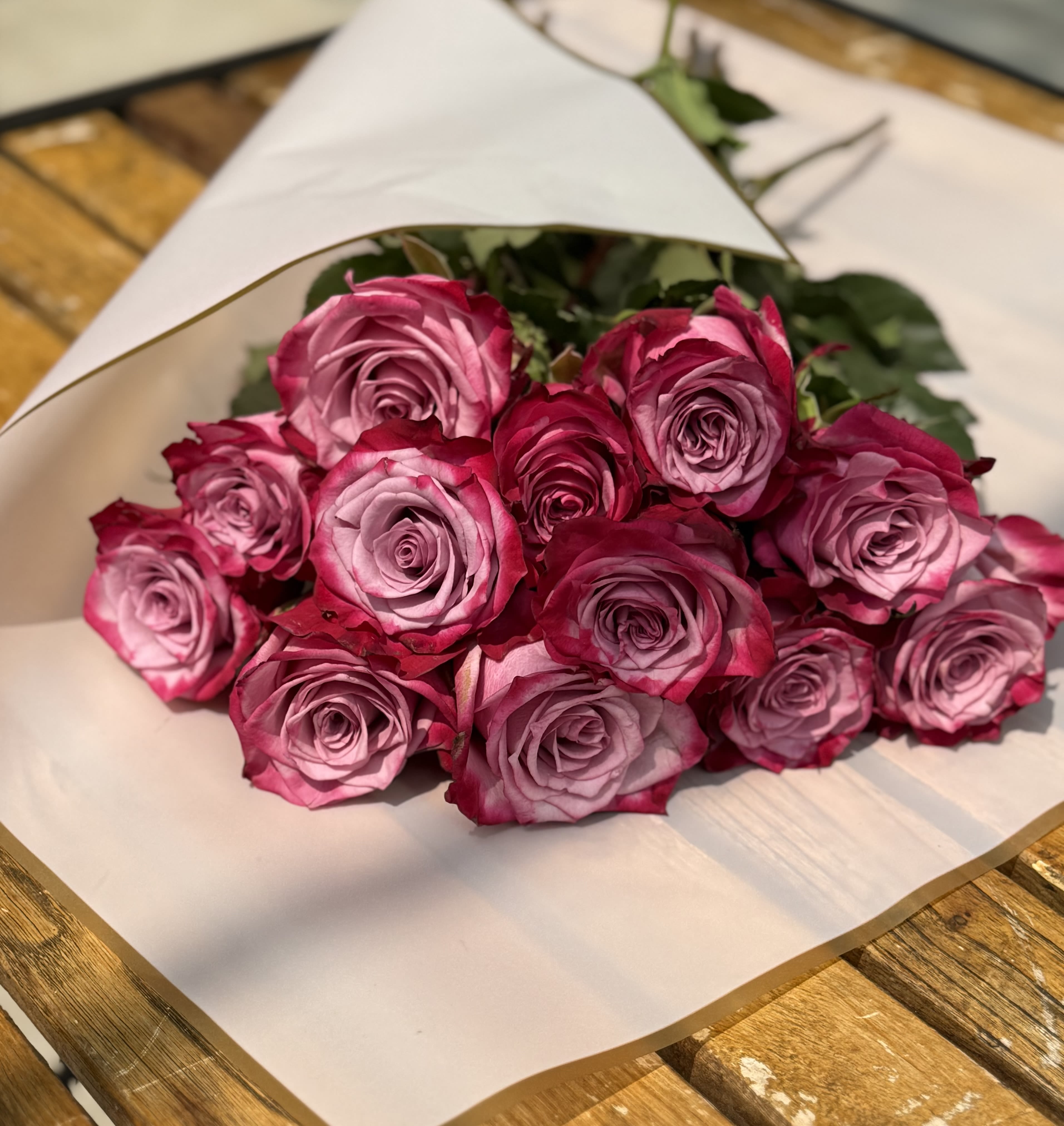 Deep Purple Rose Wrapped Bouquet  - Simply exquisite! One dozen lavender roses arranged withand assorted foliage. 