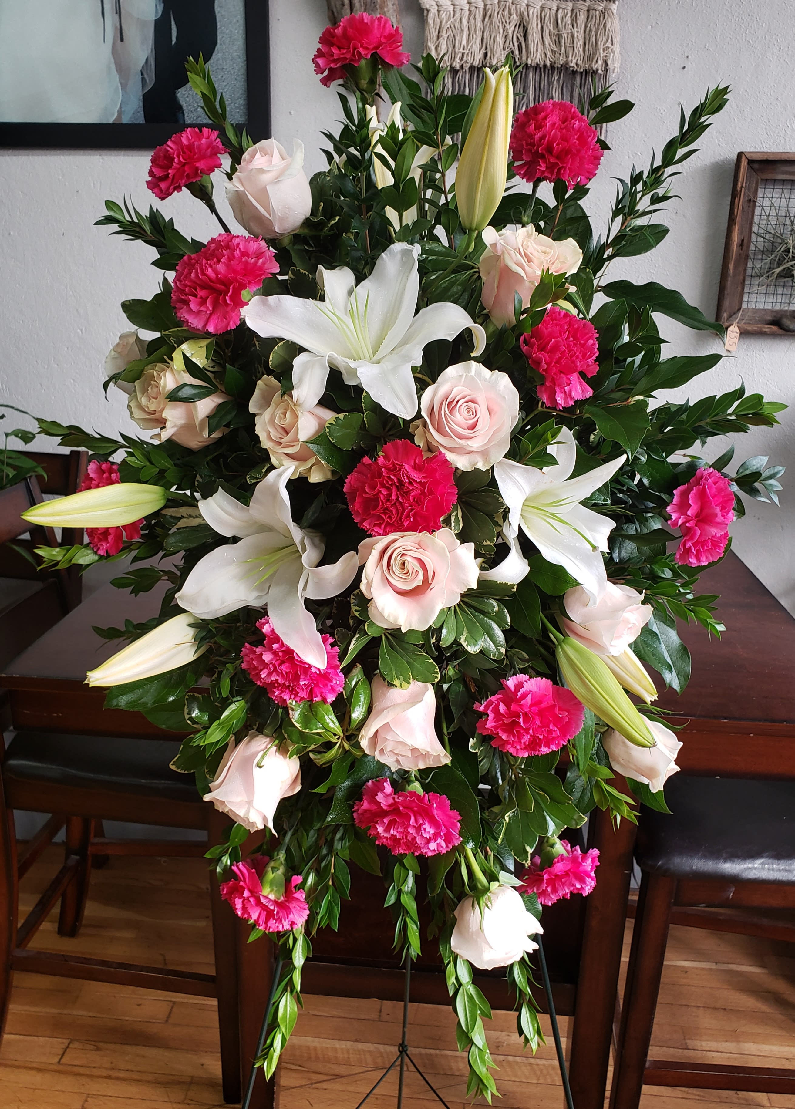 Serene Pink Easel  Spray  - A standing easel spray of pink roses, white lilies and carnations. Beautiful and fragrant. 